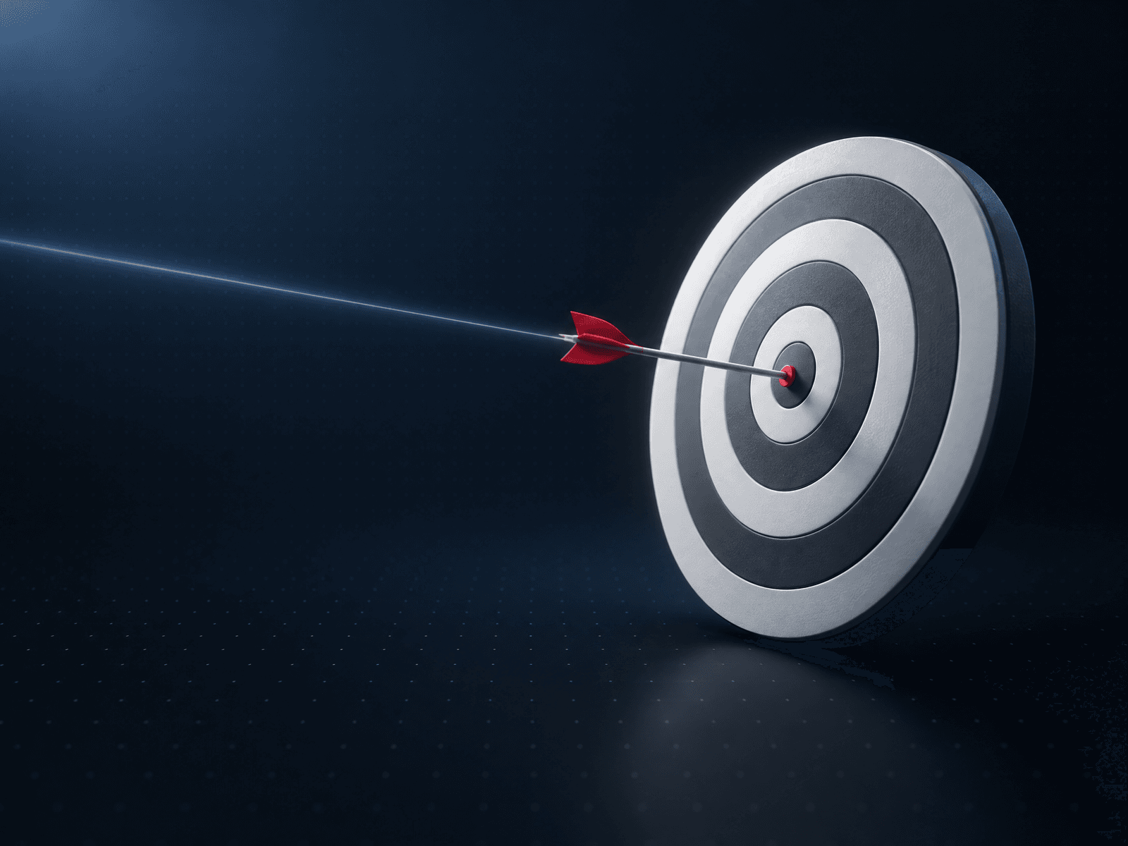 Archery target with a single red arrow in the bullseye